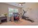 Bright home office featuring a ceiling fan, a desk with dual monitors, and a Sole elliptical trainer at 252 Timber Run Dr., Georgetown, SC 29440
