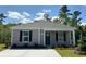 Charming single-story home showcasing a well-manicured lawn and a welcoming front entrance at 116 Arbor Crest Ln., Tabor City, NC 28463