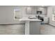 A modern kitchen featuring stainless steel appliances, gray cabinets, and light-colored countertops at 116 Arbor Crest Ln., Tabor City, NC 28463