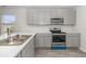 An efficient kitchen with stainless steel appliances, modern cabinets, and a light-colored countertop at 116 Arbor Crest Ln., Tabor City, NC 28463