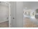 The laundry room featuring light gray vinyl plank flooring with a view of the kitchen at 116 Arbor Crest Ln., Tabor City, NC 28463
