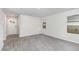Inviting living room with contemporary flooring, two windows for natural light, and an open entry door at 116 Arbor Crest Ln., Tabor City, NC 28463