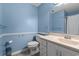 Light blue bathroom with a white vanity and shower at 6625 Scotsman Crescent, Myrtle Beach, SC 29588