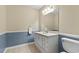 Clean bathroom, featuring a white vanity and a large mirror at 6625 Scotsman Crescent, Myrtle Beach, SC 29588