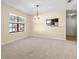 Dining room with chandelier and large window at 6625 Scotsman Crescent, Myrtle Beach, SC 29588