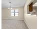 Dining room with chandelier and carpeted floor at 6625 Scotsman Crescent, Myrtle Beach, SC 29588