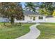 White house with landscaped lawn and walkway at 6625 Scotsman Crescent, Myrtle Beach, SC 29588