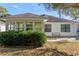 House exterior showcasing a sunroom and backyard patio at 6625 Scotsman Crescent, Myrtle Beach, SC 29588