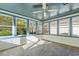 Bright sunroom with multiple windows and a ceiling fan at 6625 Scotsman Crescent, Myrtle Beach, SC 29588