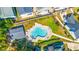 Aerial view of a pool with people and lounge chairs, surrounded by residential homes at 910 Emanon St., North Myrtle Beach, SC 29582