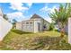 Backyard view showing the side of the house, a shed, and some grass and landscaping at 910 Emanon St., North Myrtle Beach, SC 29582