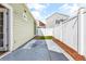 A narrow backyard space, with a concrete patio and some turf in between the fences and houses at 910 Emanon St., North Myrtle Beach, SC 29582