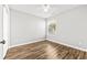 This bright, neutral bedroom has a window, ceiling fan, and attractive wood-look floors at 910 Emanon St., North Myrtle Beach, SC 29582