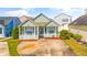 Charming single-story home featuring a well-manicured lawn and a cozy front porch with white picket fence at 910 Emanon St., North Myrtle Beach, SC 29582