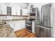 Contemporary kitchen featuring granite countertops, stainless steel appliances, and subway tile backsplash at 910 Emanon St., North Myrtle Beach, SC 29582