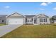 Newly constructed home with gray siding, two-car garage, and landscaped lawn at 355 Barn Owl Way, Conway, SC 29527