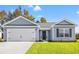 Newly built home with gray siding, two-car garage, and well-maintained lawn at 623 Snowy Owl Way, Conway, SC 29527