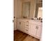 Double vanity bathroom with white cabinets and wood-look floors at 882 Liberty Church Rd., Loris, SC 29569