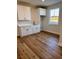 Bright laundry room with white cabinets and wood-look floors at 882 Liberty Church Rd., Loris, SC 29569