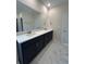 Double vanity bathroom with dark cabinets and quartz countertops at 573 Beckham Ct., Murrells Inlet, SC 29576