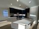 Modern kitchen featuring dark cabinetry, quartz countertops, and stainless steel appliances at 573 Beckham Ct., Murrells Inlet, SC 29576