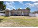 Brick home's backyard with a grass area, patio, and white fence at 9138 Wildwood Pl., Murrells Inlet, SC 29576