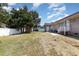 Backyard with a brick home, grass area, patio, and white fence at 9138 Wildwood Pl., Murrells Inlet, SC 29576