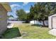 Backyard with a large grass area, trees, and a shed at 9138 Wildwood Pl., Murrells Inlet, SC 29576