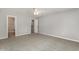 Neutral bedroom with a ceiling fan, carpeted floors, and closet access at 9138 Wildwood Pl., Murrells Inlet, SC 29576