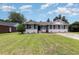 Traditional brick house with well maintained lawn, black shutters, and ample parking at 9138 Wildwood Pl., Murrells Inlet, SC 29576