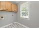 Laundry room features storage cabinets and natural light at 9138 Wildwood Pl., Murrells Inlet, SC 29576