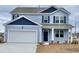 Two-story light blue house with a white garage door and dark blue accents at 1139 Ridgeford Dr., Conway, SC 29526