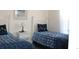 Two twin beds in a well-lit bedroom with matching bedding at 501 Maison Dr. # B3, Myrtle Beach, SC 29572