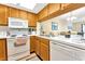 Well-equipped kitchen with wood cabinets and appliances at 501 Maison Dr. # B3, Myrtle Beach, SC 29572