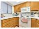 Efficient kitchen with wood cabinets, a stove, and microwave at 501 Maison Dr. # B3, Myrtle Beach, SC 29572