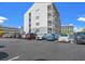 Exterior view of parking lot with cars parked and building in background at 2000 S Ocean Blvd. # 203V, Myrtle Beach, SC 29577