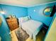 Inviting bedroom with blue walls, wooden dresser, bed, decor and a comfortable rug at 6001 - 1795 S Kings Hwy., Myrtle Beach, SC 29575