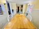 Dining room with a large wooden table and seating for six, illuminated by sconces and lots of natural light at 6001 - 1795 S Kings Hwy., Myrtle Beach, SC 29575