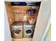 Functional laundry area featuring a washer, dryer, and storage shelves, optimizing space in the home at 6001 - 1795 S Kings Hwy., Myrtle Beach, SC 29575