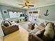Charming living room features a ceiling fan, sliding glass doors, and cozy couches, perfect for relaxation at 6001 - 1795 S Kings Hwy., Myrtle Beach, SC 29575