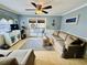 Comfortable living room with ceiling fan, sliding glass doors, TV, and cozy couches, great for relaxation and entertainment at 6001 - 1795 S Kings Hwy., Myrtle Beach, SC 29575