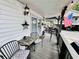 Relaxing covered porch with comfortable seating and decorative touches. American flag at 6001 - 1795 S Kings Hwy., Myrtle Beach, SC 29575