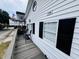 Charming coastal home featuring a spacious porch, black shutters, and a bright, welcoming design at 6001 - 1795 S Kings Hwy., Myrtle Beach, SC 29575