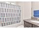 Bathroom with patterned shower curtain, granite countertop, and a modern faucet at 1266 Brighton Hill Ave., Myrtle Beach, SC 29588