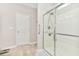 A bright bathroom features a glass-enclosed shower with a tiled floor and white door at 1266 Brighton Hill Ave., Myrtle Beach, SC 29588