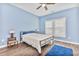 Bright bedroom with a large window, ceiling fan, wood-look floors and blue accent wall at 1266 Brighton Hill Ave., Myrtle Beach, SC 29588