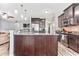 Open concept kitchen with a granite island, stainless steel refrigerator and wood cabinets at 1266 Brighton Hill Ave., Myrtle Beach, SC 29588