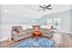 Comfortable living room with a ceiling fan, gray sofa, area rug, and lots of natural light at 1266 Brighton Hill Ave., Myrtle Beach, SC 29588