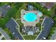 Aerial view of a community pool with a hot tub, parking, and meticulously landscaped grounds at 1266 Brighton Hill Ave., Myrtle Beach, SC 29588