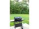 A backyard with a grill and a large grass lawn at 157 Blue Jacket Dr., Galivants Ferry, SC 29544